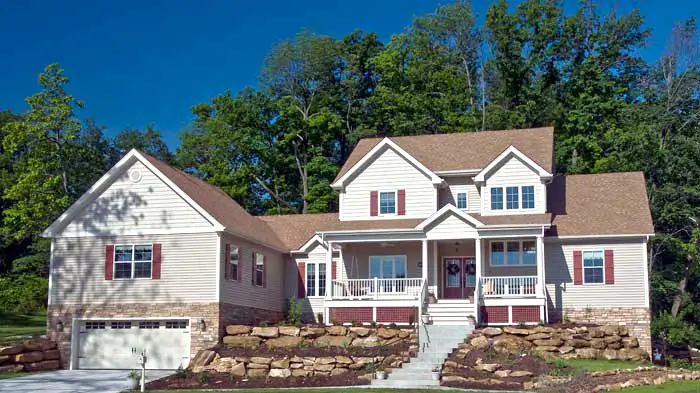 A new home build in Kirkwood MO by Agape Construction, featuring landscaped rock work in theme with the home accent colors.