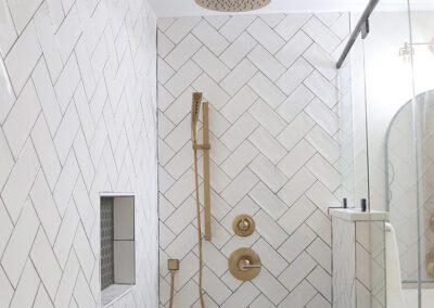 primary suite shower with herringbone tile