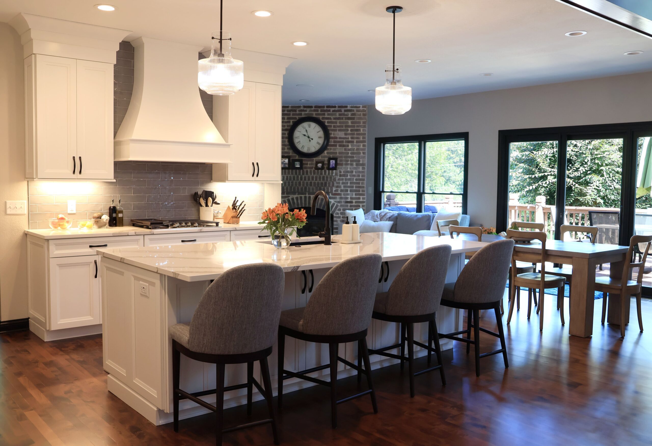 spacious white kitchen opens to hearth room and living room