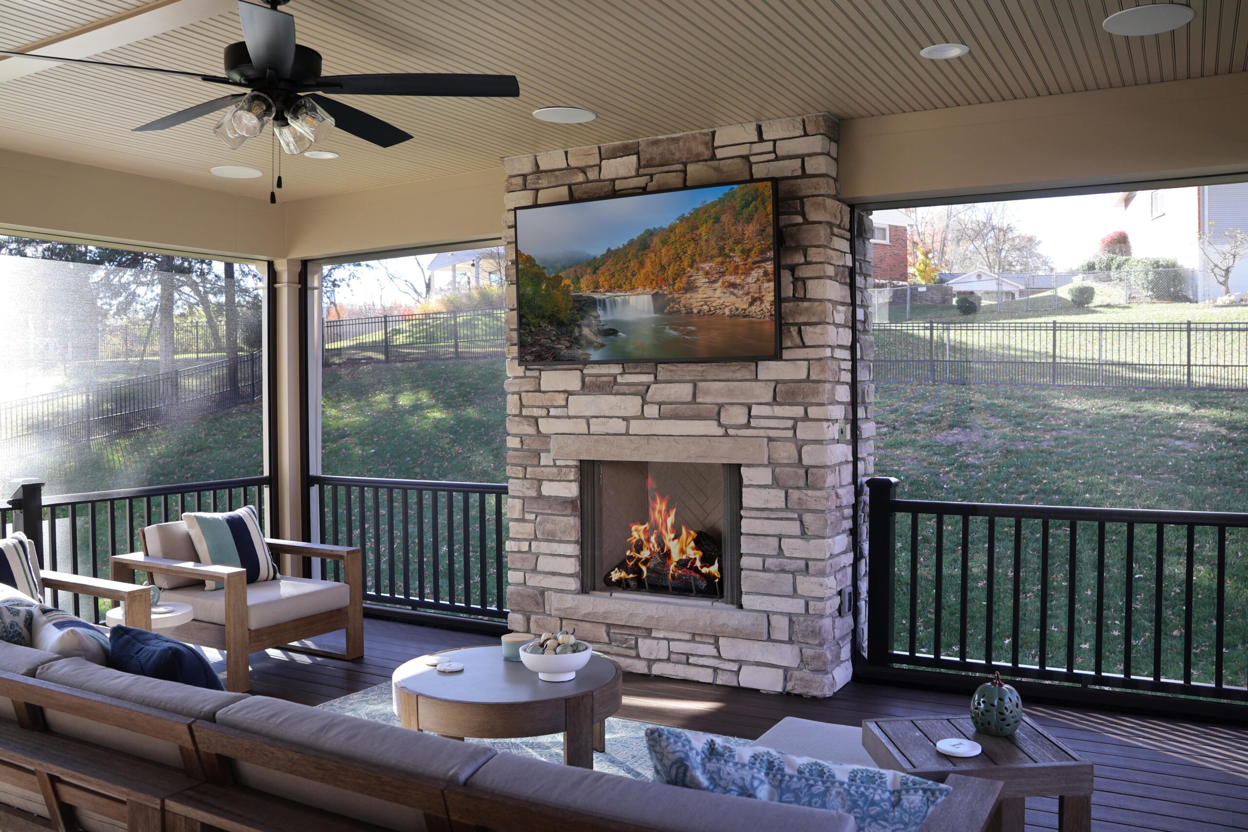 screened in deck with stone fireplace