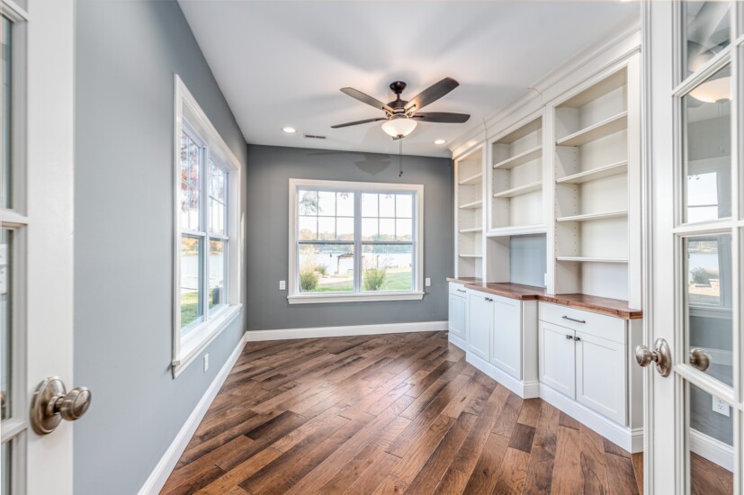 home office custom bookshelves wood lake view hardwood floor grey walls