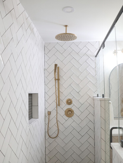 primary suite shower with herringbone tile