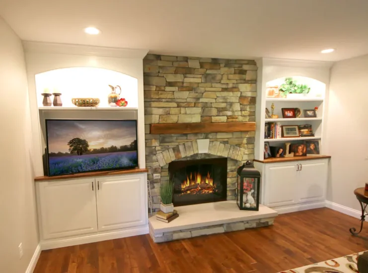A Chesterfield, MO, home's cobblestone fireplace, featuring custom-cut wood, by Agape Construction.