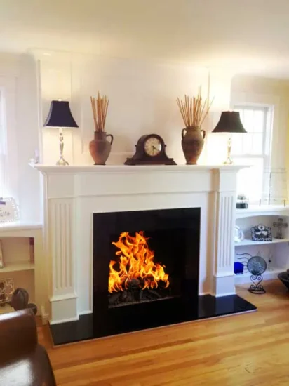 A classical-style fireplace with matching shelving, by Agape Construction.