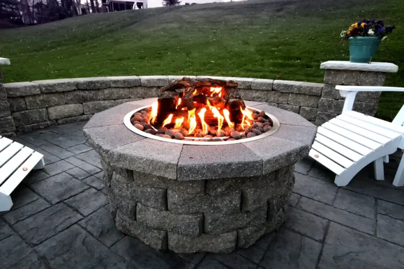 Outdoor gathering space with fire pit, by Agape Construction.