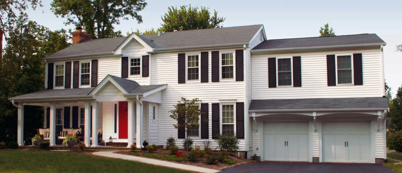 A second-story extension over two-door garage shutters, completed by Agape Construction.