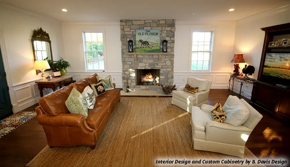 A home living space with natural stone fireplace, by Agape Construction.
