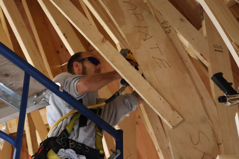 construction worker building a trellis