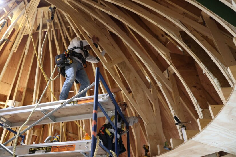 two workers building a trellis