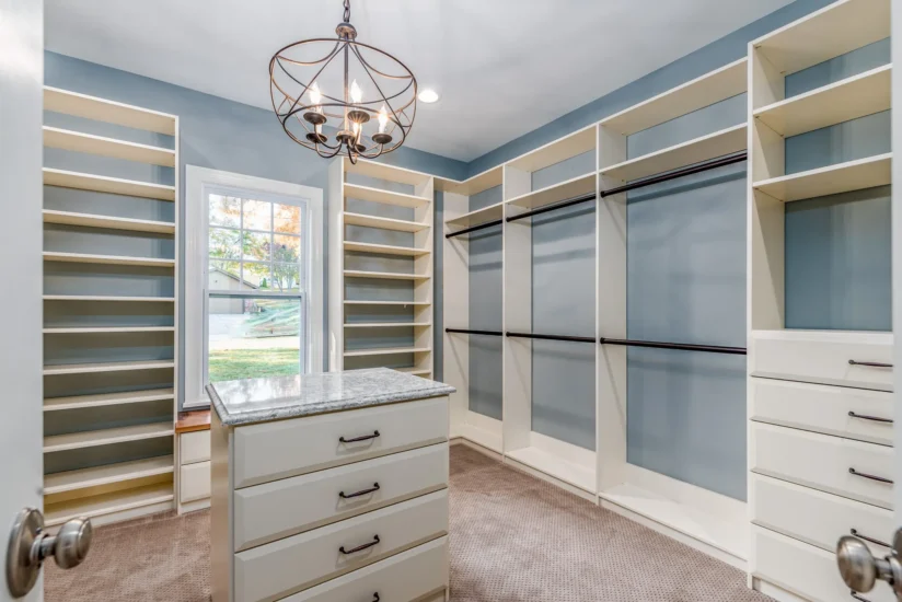 Closet space within a primary bedroom in a St. Louis, MO, home. By Agape Construction.