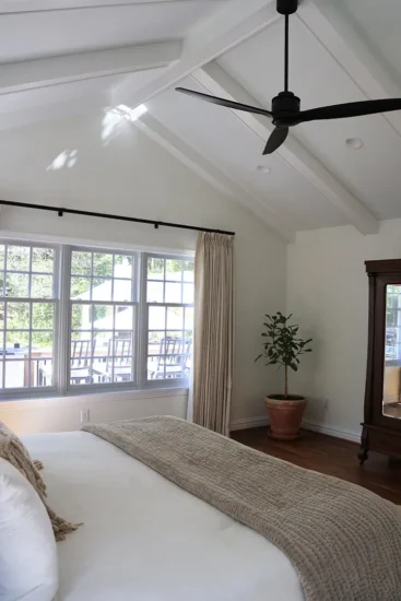 A primary bedroom suite with ample natural light, by Agape Construction.