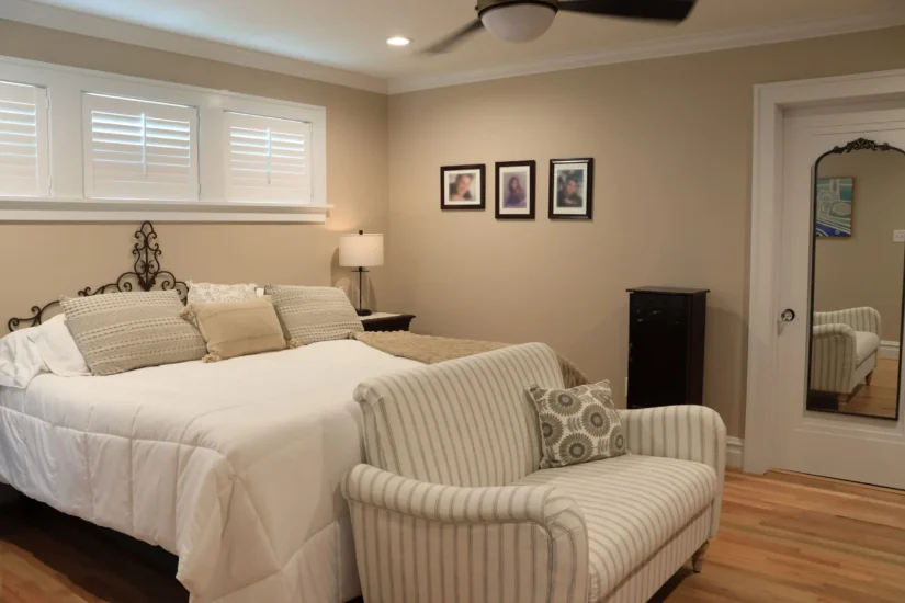Primary bedroom, post-renovation by Agape Construction, featuring more living space with a bump-out.