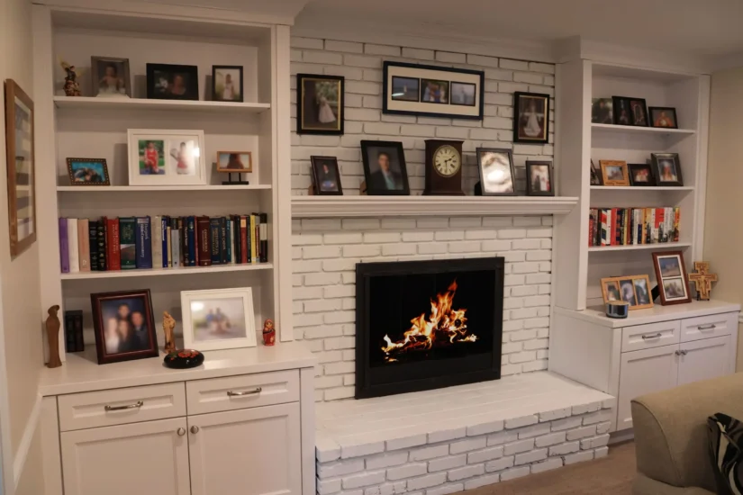 A custom home fireplace with integrated book shelving, by Agape Construction.