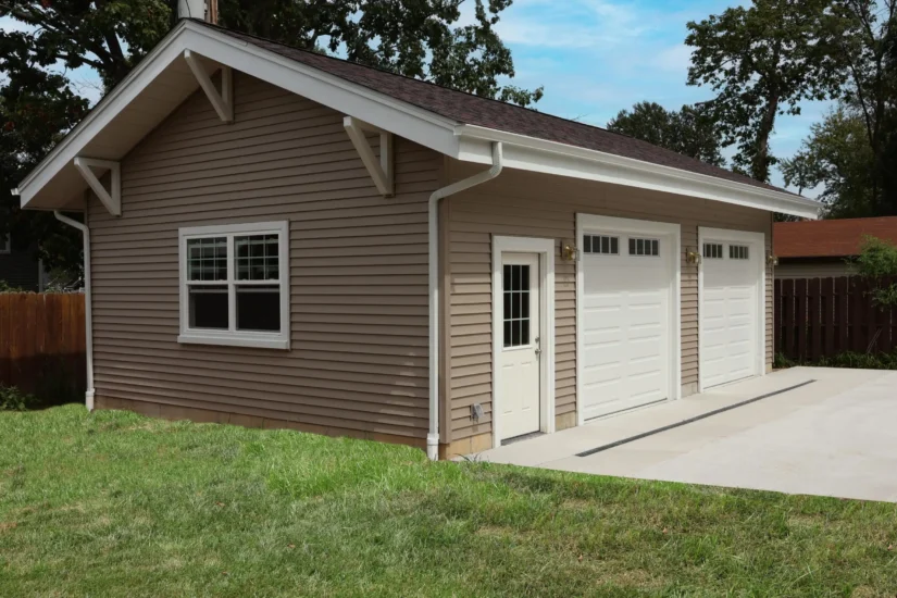 A detached 2-car garage with matching accents to the home, by Agape Construction.
