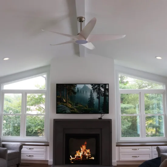 A vaulted ceiling sunroom with fireplace and wall-mounted TV. By Agape Construction.