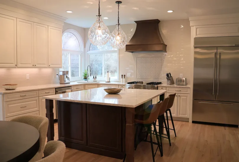 open concept white kitchen with dark wood island