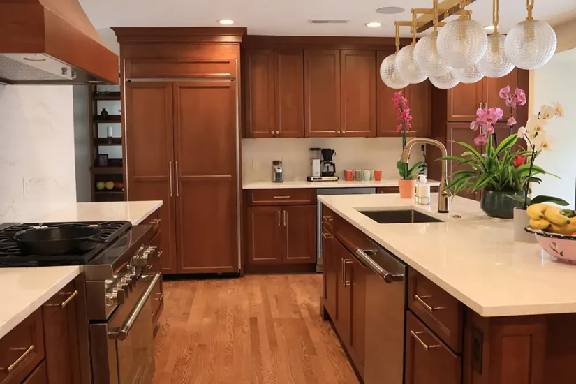 traditional kitchen with cherry cabinets large center island and artistic lighting