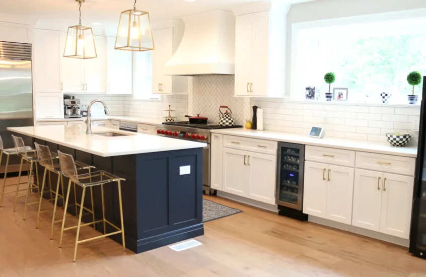 expanded kitchen with two toned blue and white cabinetry and unique herringbone backsplash