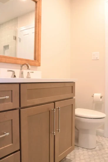 guest bath with light wood cabinetry
