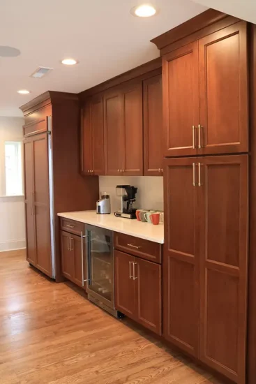 wall of cherry cabinets and beverage fridge