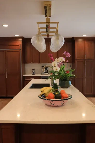 traditional kitchen with cherry cabinets large center island and artistic lighting