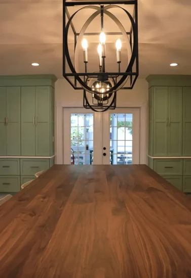 large open country style kitchen with green cabinetry